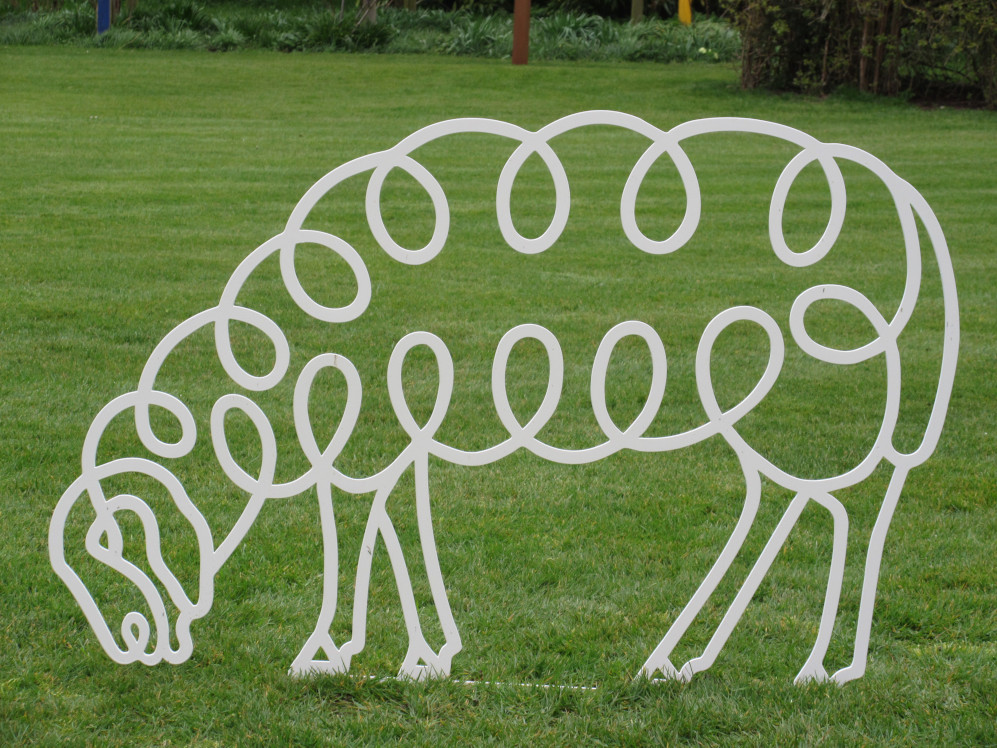 grazing sheep are steel garden sculptures by Henrietta Bud